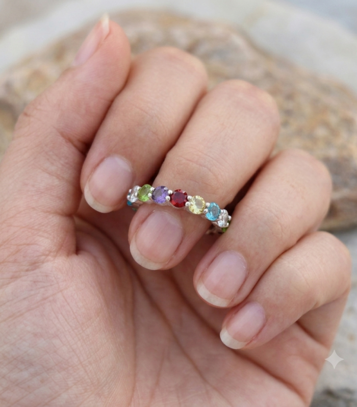 925 sterling silver eternity band ring set with a continuous row of multi-colored round gemstones.