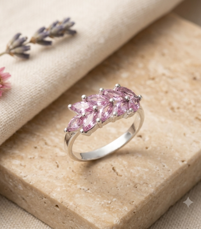 925 sterling silver band ring set with a cluster of marquise-cut pink gemstones in a leaf design.